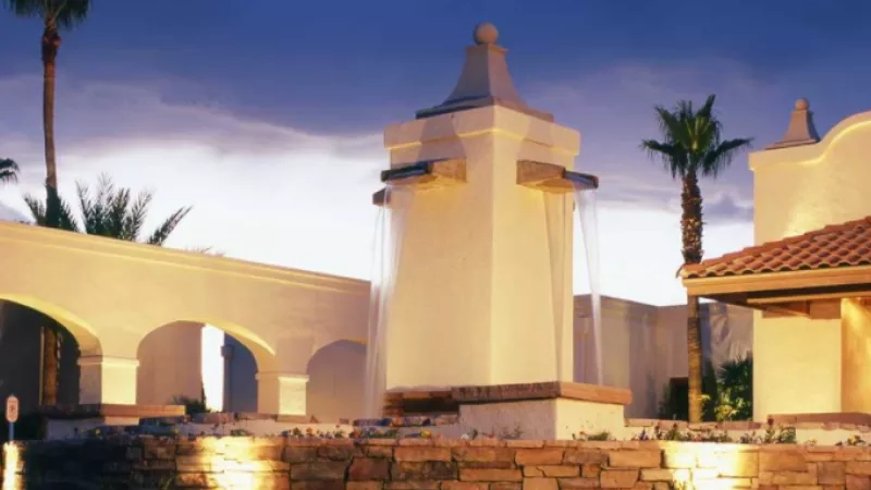 Evening view of the Rio Rico Resort, featuring architectural details, landscaping, and ambient lighting.