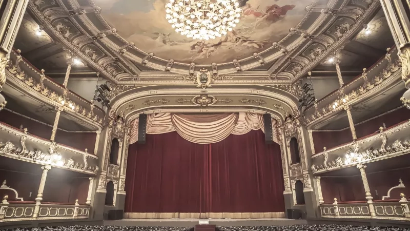 San Jose Costa Rica, view of the theater from the balcony with red curtain and golden chandelier.