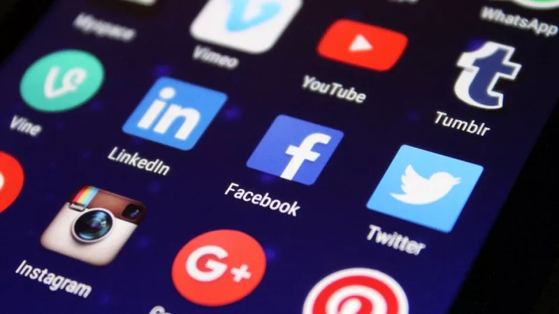 Smartphone screen with social media apps like Facebook, Twitter, Instagram, and Google Plus.