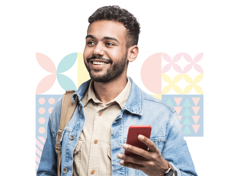 Smiling man wearing denim jacket and beige shirt using red smartphone with colorful geometric background behind him.