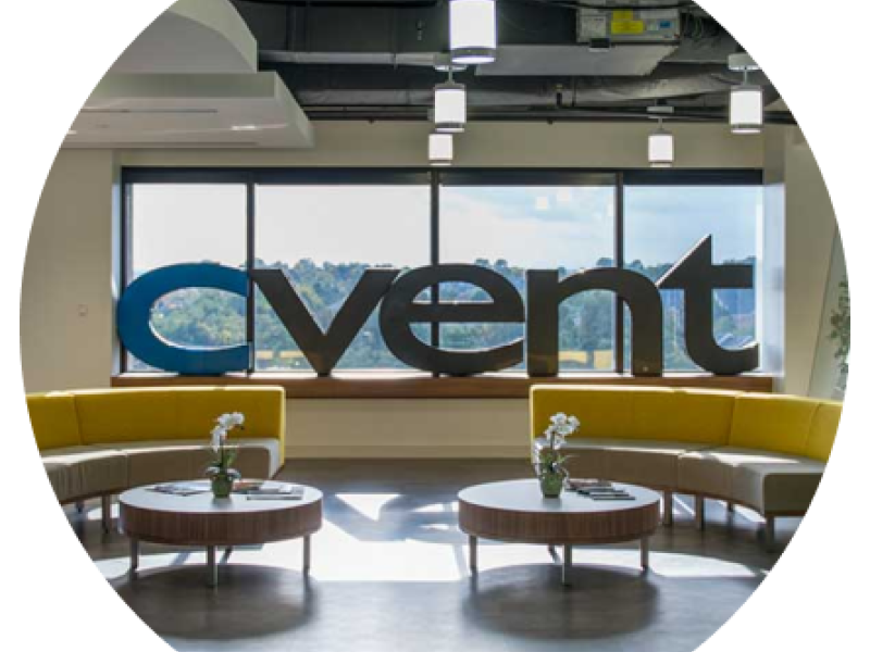 Cvent's office with couches, tables, a big window, and the word "cvent" on it.