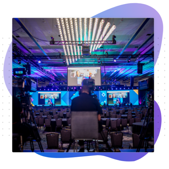 Vendor marketplace at a virtual event with purple and green lighting and a stage in the background.