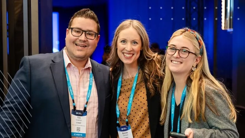Three people wearing lanyards with "cvent" written on them stand together for a photo.